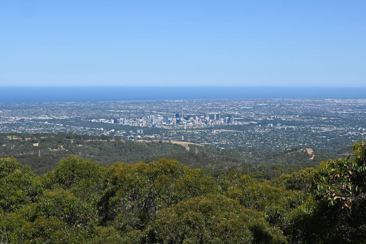 Aerial view of Adelaide city centre and CBD from Mount Lofty Summit in South Australia showing the urban grid and surrounding hills