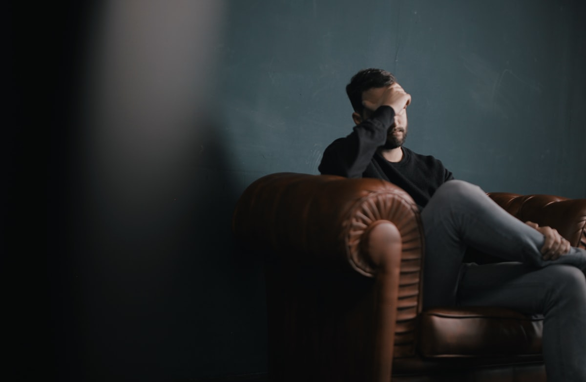 Person holding head in pain representing the 4.9 million Australians living with migraine who are exploring medicinal cannabis as a preventive and acute treatment option