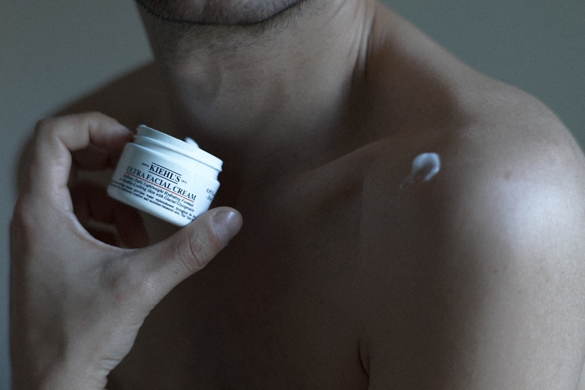 Person holding a jar of skin cream representing topical cannabis products used for localised pain and inflammation relief