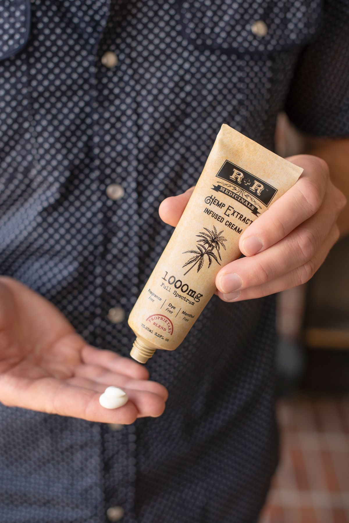 Person applying moisturising cream to their hands representing cannabis topical products for localised pain and skin conditions