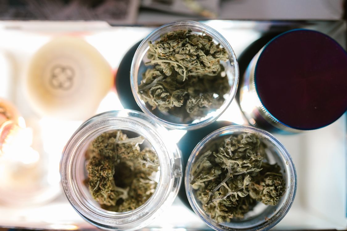 Cannabis flower buds in a clear glass jar representing product selection for first-time cannabis buyers in Australia