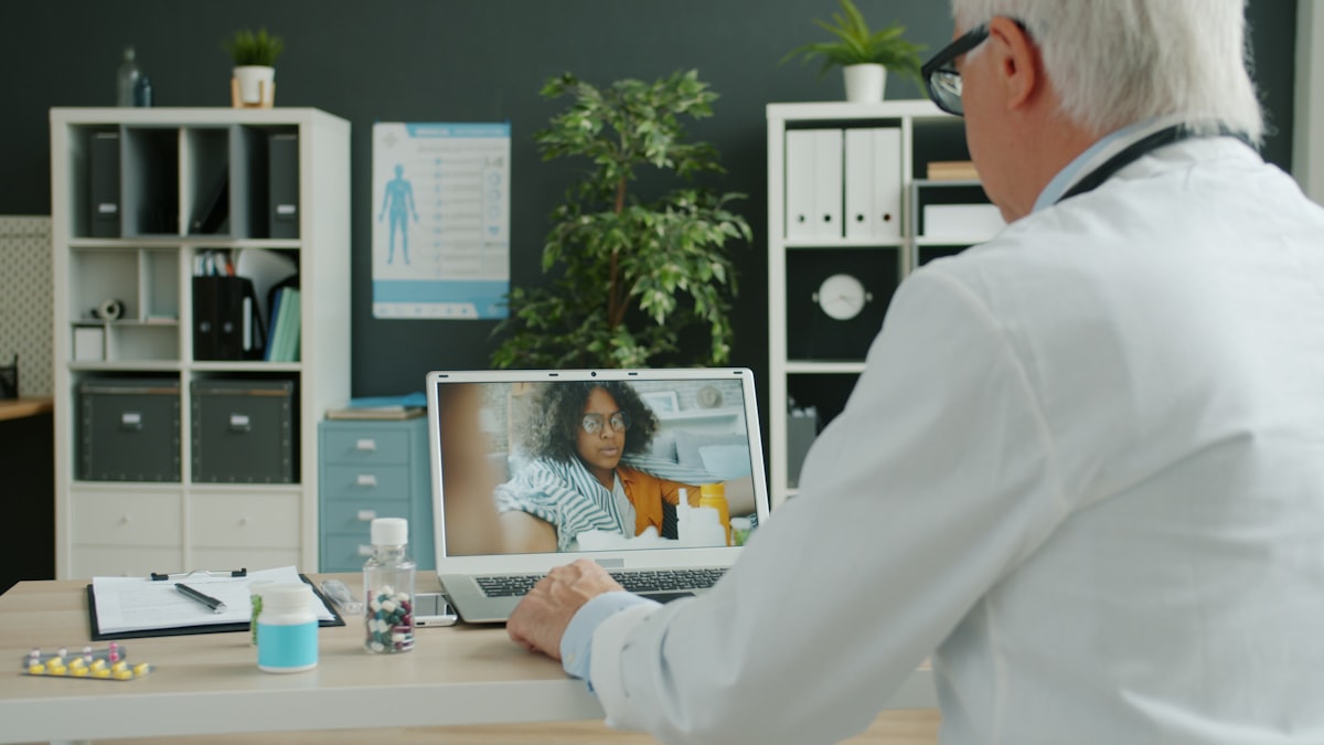 Doctor conducting a video telehealth consultation with a patient on a screen representing Alternaleaf's online cannabis prescribing service