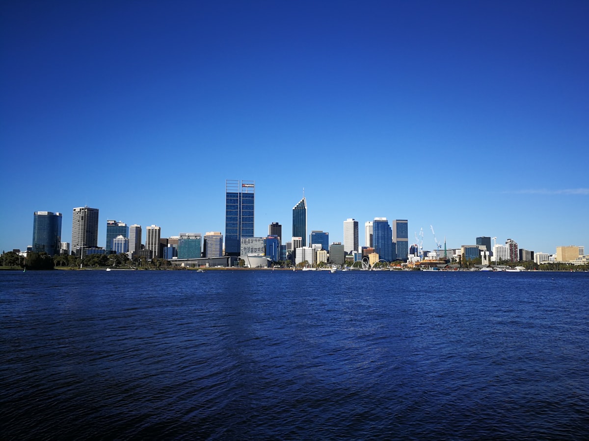 Perth city skyline reflected across the Swan River during daytime showing the Western Australian capital's modern CBD