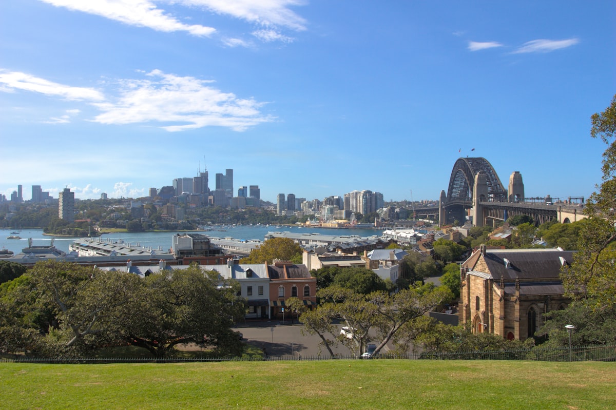 Sydney Harbour Bridge and North Sydney cityscape viewed from Observatory Hill on a clear sunny day