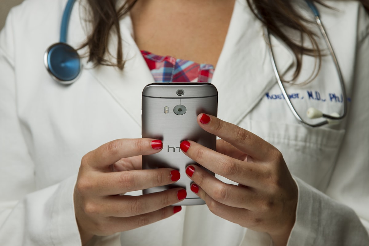 Healthcare professional using a smartphone for telehealth consultation representing Tetra Health's digital-first medicinal cannabis prescribing service